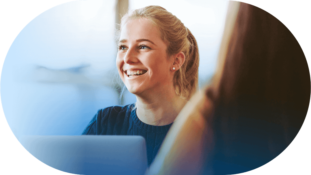 young woman smiling in office meeting frame 1@2x