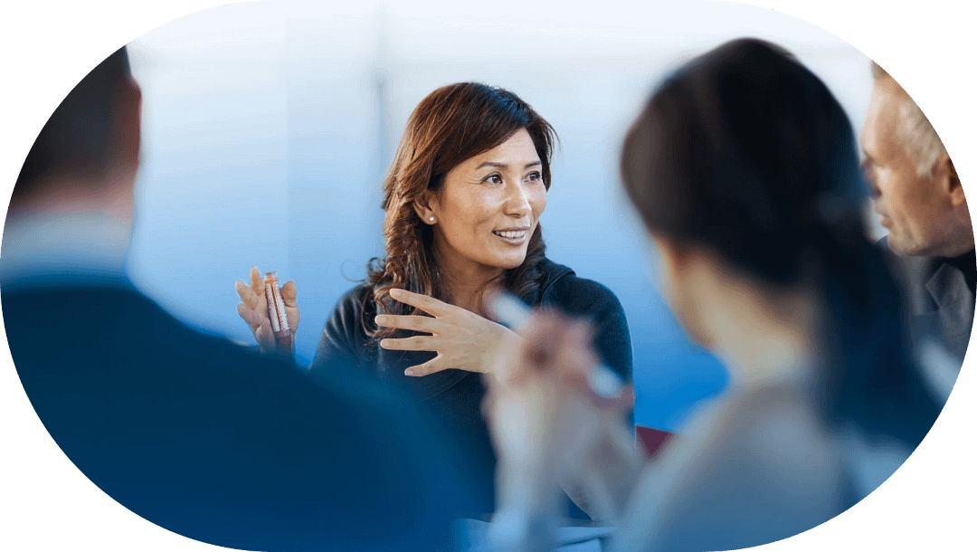 professional woman speaking in team discussion frame 2@2x