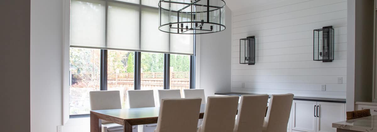 Motorized window shades in a modern living room, providing effortless light control and enhancing home automation.