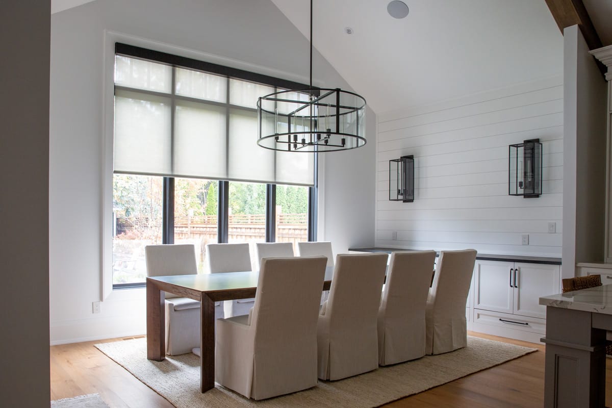 Motorized window shades in a modern living room, providing effortless light control and enhancing home automation.