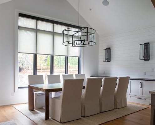 Motorized window shades in a modern living room, providing effortless light control and enhancing home automation.